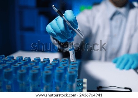 A researcher is taking notes. It is being developed in the lab as a profile for other researchers, A biological chemical scientist is writing a report on his day's work for a boss.