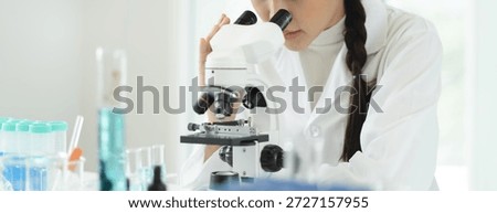 researcher using microscope analyse cell in medical lab.