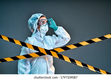 Researcher Wearing Hazmat Protective Suit And Safety Goggles. Side View. Isolated Grey Background