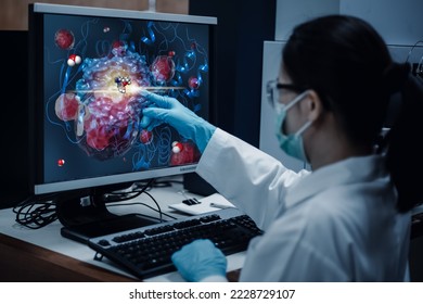 Researcher woman indicates the position of drug sample in the modelling simulation of drug development as shown on a computer monitor. The analytical computer is a supercomputer for drug simulation. - Shutterstock ID 2228729107