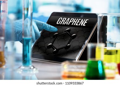 Researcher Working In The Lab With Screen Computer And Conceptual Representation Of Graphene Material / Engineer Working In The Research Laboratory With The Tablet And Symbol Graphene In The Screen