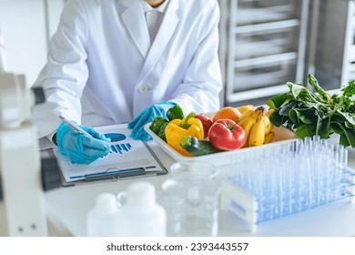 Researchers inspecting vegetables and fruits. - Powered by Shutterstock