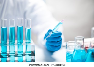 Researchers scientist working analysis with blue liquid test tube in the laboratory, chemistry science or medical biology experiment technology, pharmacy development solution