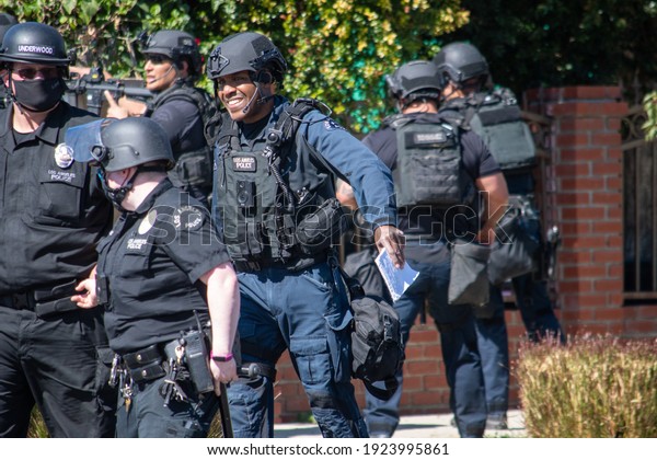 Reseda, California, United States - February 24,\
2021:  LAPD Swat team, officers, and LAFD Firefighters and\
helicopters respond to a report of a gunman in a Reseda.  One\
suspect was taken into\
custody