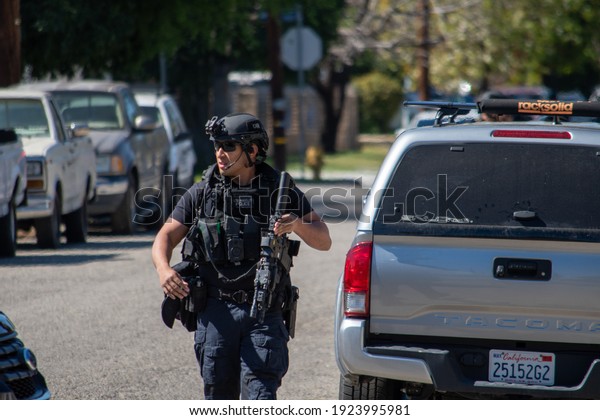 Reseda, California, United States - February 24,
2021:  LAPD Swat team, officers, and LAFD Firefighters and
helicopters respond to a report of a gunman in a Reseda.  One
suspect was taken into
custody