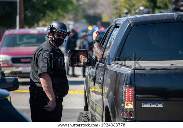 Reseda, California, United States - February 24,
2021:  LAPD Swat team, officers, and LAFD Firefighters and
helicopters respond to a report of a gunman in a Reseda.  One
suspect was taken into
custody