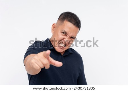 A resentful middle aged man snarling and blaming someone for his failures. Isolated on a white background.