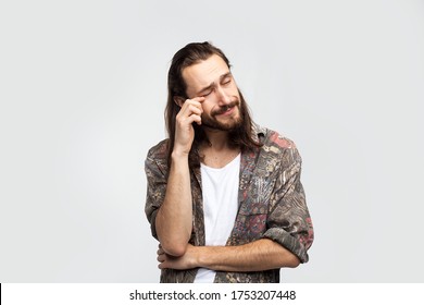 Resentment crying and tears, sentimental gentle man sad and emotional. Hipster traveler stylish carefree man on a white studio background, people lifestyle