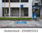 Reserved disability parking spot at a HDB carpark in Singapore, with floor markings and sign post for the handicapped.