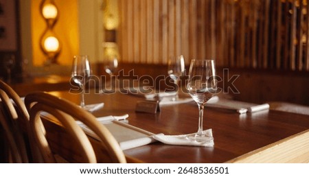 Reserved, empty and table setup at restaurant for private event, celebration and dining experience. Glasses, layout and interior setting with catering service, lunch banquet and party for New years
