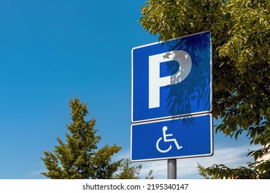Reserved parking space sign, handicapped person with disability in wheelchair pictogram, selective focus