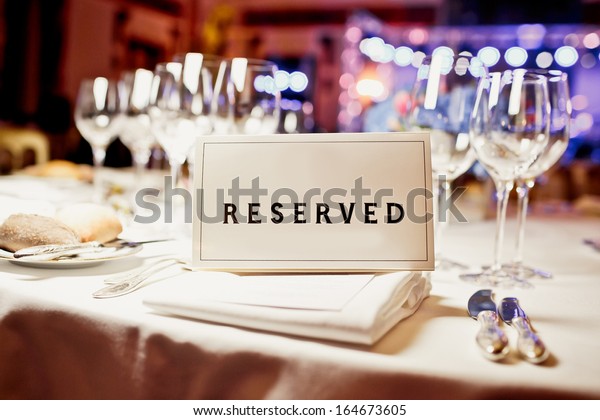 Reserved sign on a table in\
restaurant