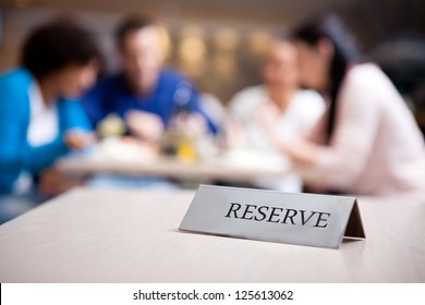 reserved table at nice restaurant with guests in the background