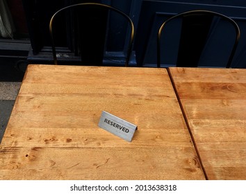 A Reserved Tent Sign On A Table Outside A Pub Offering Outdoor Drinking And Dining Only During The Coronavirus Covid 19 Pandemic Restrictions Lockdown Period.