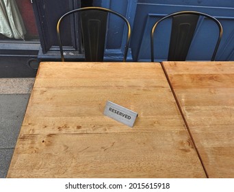 A Reserved Tent Sign On A Table Outside A Pub Offering Outdoor Drinking And Dining Only During The Coronavirus Covid 19 Pandemic Restrictions Lockdown Period.