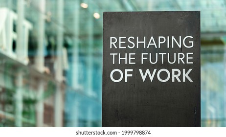 Reshaping The Future Of Work On A City-center Sign In Front Of A Modern Office Building	
