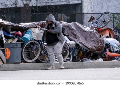 A Resident Of A Homeless Encampment Is Seen Near A Billboard Along The Railway Track In Los Angeles, March 3, 2021. 