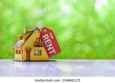 Residentail house / home for rent, mortgage concept : Model house and a tag with a word RENT, depict unoccupied house for tenant or renter who don't want to own an asset and pay less fee to save money - Shutterstock ID 1544841173