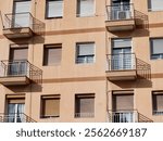 Residential Apartment Facade with Balconies and Windows in Natural Light