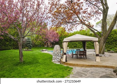 Residential  Backyard With Gazebo, Deck, Stone Patio And Swimming Pool