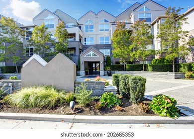 Residential Building With Landscape. View Of Welcoming Sign In Park Avenue Apartment Complex