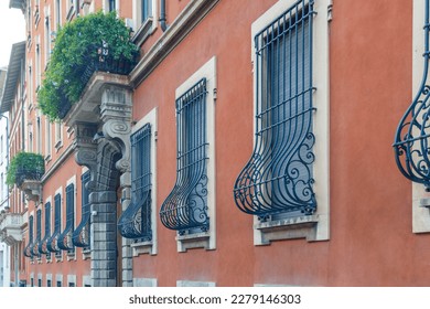 Residential building with wrought iron bars on the windows in Milan. High quality photo