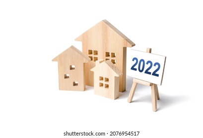 Residential Buildings And Easel 2022. Concept Of Real Estate Market In New Year. Housing Market Predictions, Trends And Tendencies. Investment Plans. Mortgage Loan. Economic Analysis. Home Loans