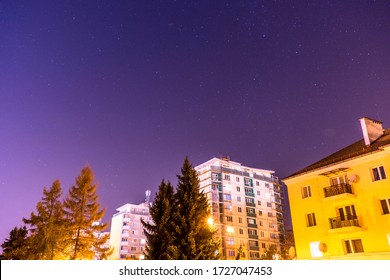 residential buildings at night with the pinkish sky being full of stars in Slovakia. - Powered by Shutterstock
