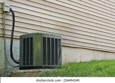 A Residential Central Air Conditioning Unit Sitting Outside A Home Used For Regulating The Homes AC To A Comfortable Level.