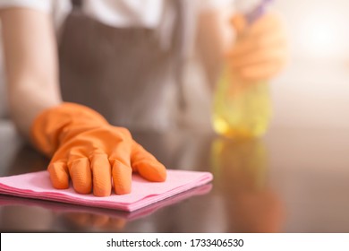 Residential Cleaning Service Concept. Closeup Of Housemaid's Hand Cleans Dust From Table With Rag, Selective Focus