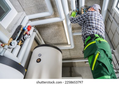 Residential and Commercial Modern Natural Gas Heating Systems Installation Performed by Professional Caucasian HVAC Technician in His 40s. - Shutterstock ID 2258653797