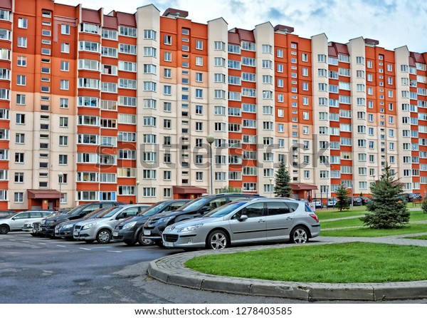 Residential complex. Cars in a yard. Beautiful\
residential buildings in East Europe. Architecture. Construction\
industry and development of urban infrastructure. Belarus, Minsk –\
August  19, 2017 