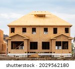 A residential duplex house construction project showing the plywood roof and oriented strand board wall sheathing