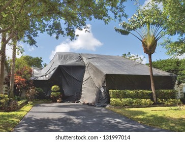 A residential dwelling is tented to exterminate termites and other insects. - Powered by Shutterstock