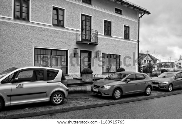 Residential house with a\
balcony and big windows. Cars in a parking lot. Urban landscape.\
Modern German town. Accommodation. West Europe. Germany, Zorneding\
– November 19, 2017\
