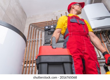 Residential HVAC Service Worker Performing Natural Gas Heating System Check. Caucasian Technician With Toolbox In His Hand. 