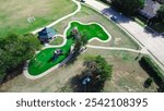 Residential neighborhood parked car on street near playground artificial turf, pavilion and climbing, sliding structure at community recreational facility, shaded kids playing structure, Dallas. Texas