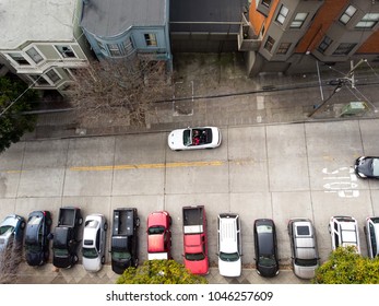 Residential parking on city street of San Francisco with cars on it.