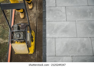 Residential Patio Brick Floor Paving And Soil Compacting. Backyard Improvement Theme.