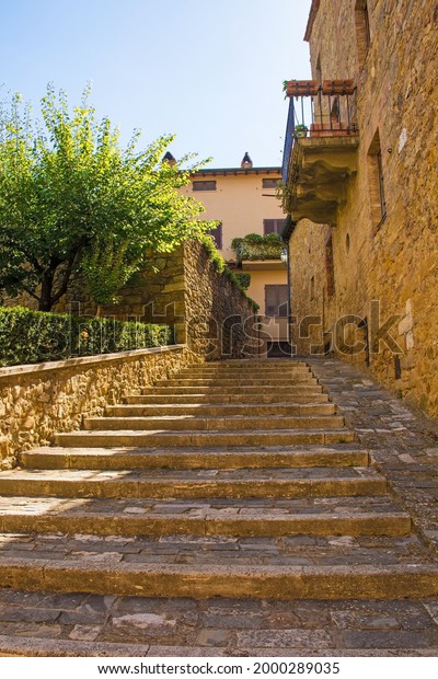 A residential\
road in the historic medieval village of San Quirico D\'Orcia, Siena\
Province, Tuscany, Italy\
