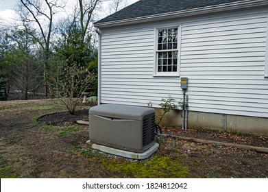 Residential standby generator installed on a concrete pad