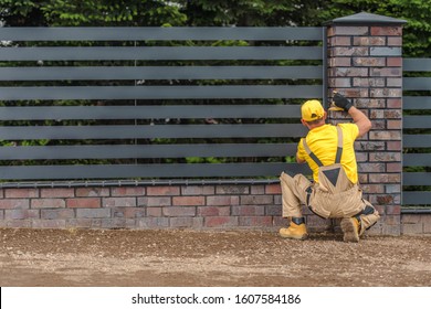 Residential Stylish Metal Panels Fence Building By Professional Fencing Contractor Worker.