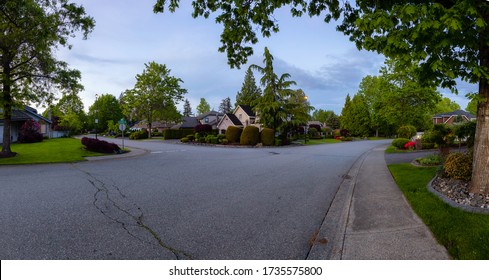 Residential Suburban Neighborhood in the City during a vibrant spring sunset. Taken in Fraser Heights, Surrey, Vancouver, BC, Canada. Panorama, Wide Angle
