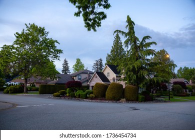 Residential Suburban Neighborhood in the City during a vibrant spring sunset. Taken in Fraser Heights, Surrey, Vancouver, BC, Canada.