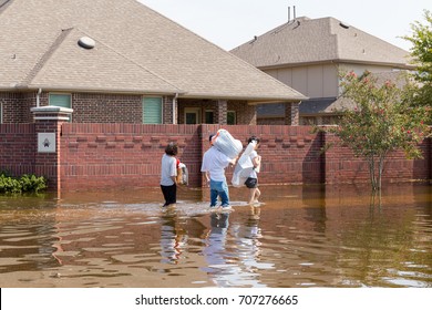 Residents in walk in high waters after devastating floods in Houston suburb