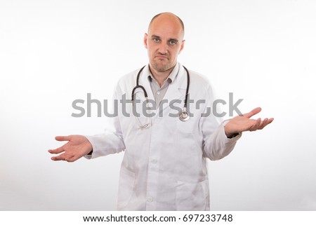 Resigned unhappy doctor shrugging his shoulders to show his ignorance or inability to help a patient