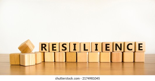 Resilience Symbol. Word 'Resilience' Written On Wooden Blocks. Copy Space. Beautiful Wooden Table, White Background. Business And Resilience Concept.