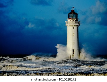 A Resilient Lighthouse Standing Up To Crashing Waves During A Storm