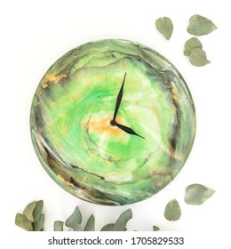 Resin Art Clock And Eucaliptus Leaves Isolated On White Background. Flat Lay, Top View