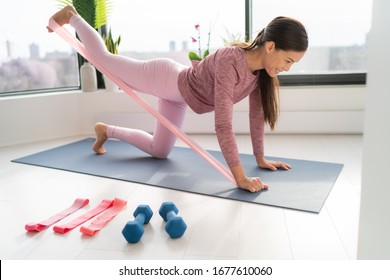 Resistance Band Fitness At Home Asian Woman Doing Leg Workout Donkey Kick Floor Exercises With Strap Elastic. Glute Muscle Activation With Kickback For Thighs Cellulite.